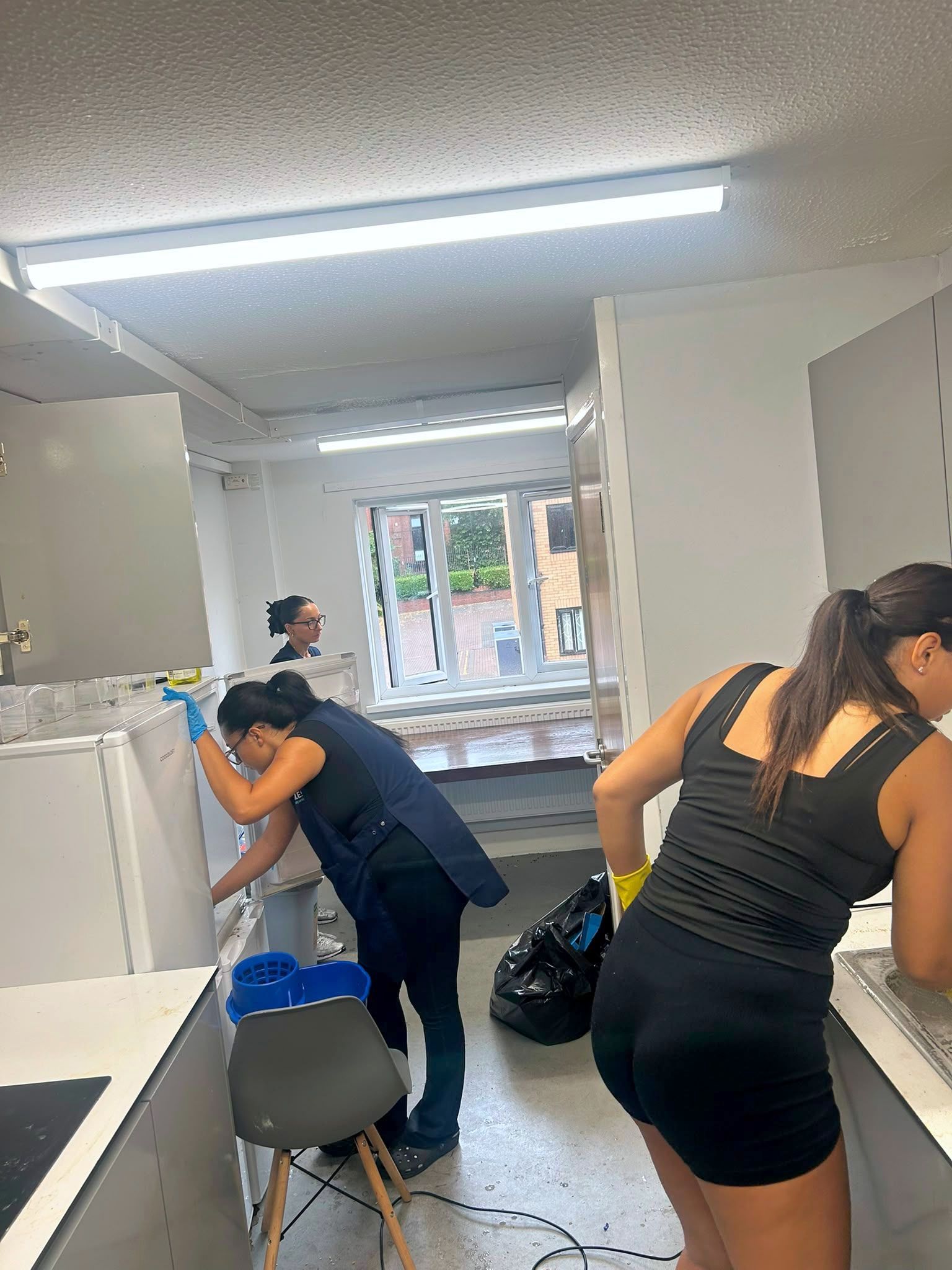 Giles Cleaning Services team deep cleaning a shared kitchen